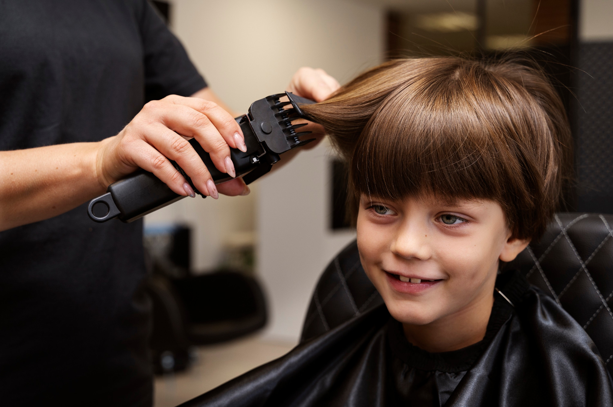 Child having a haircut in a salon